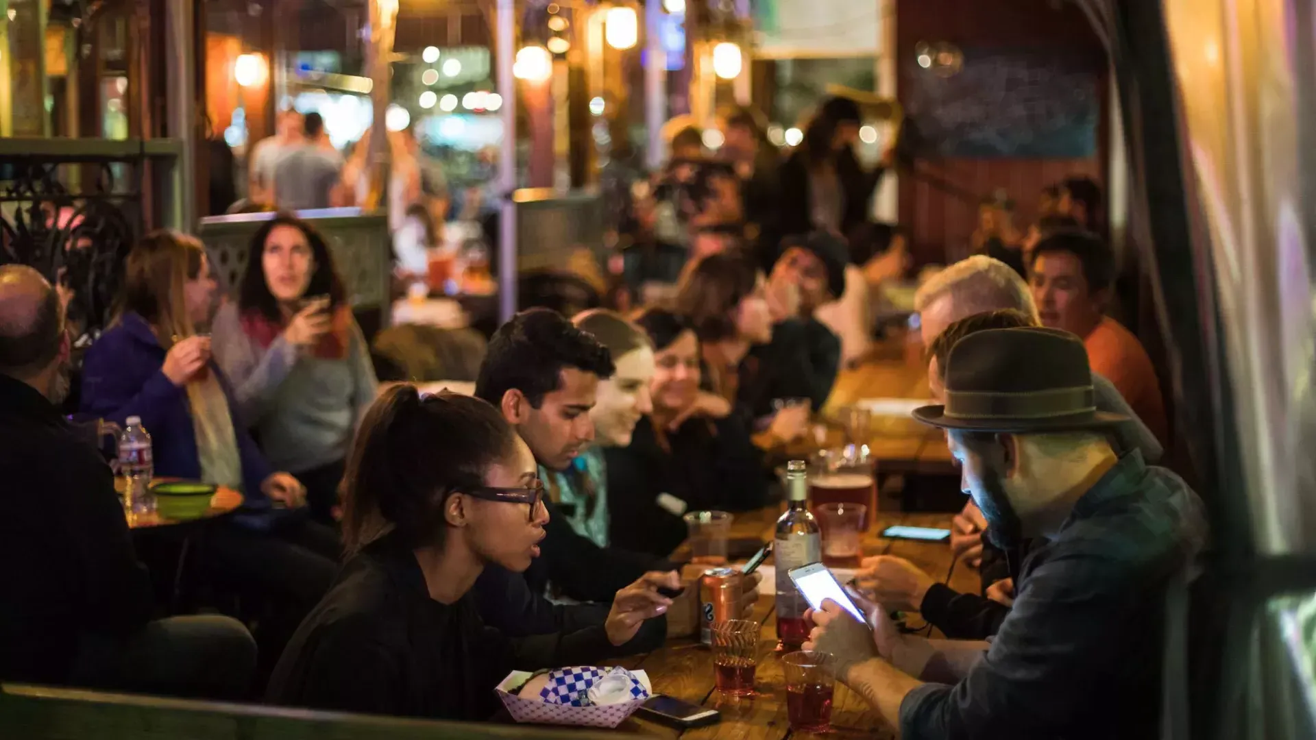 People eating in a crowded dining area in SoMa. San Francisco, California.